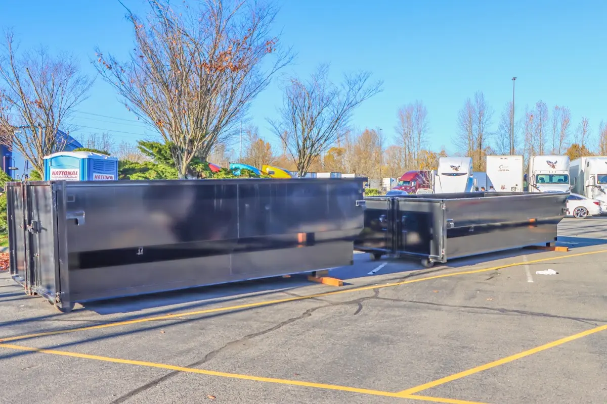 Professional dumpster rental service with roll-off container on residential driveway in Cheektowaga